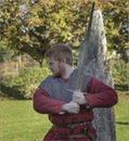 Red haired youth in vintage dress with a sword