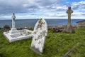 Llandudno , Wales, UK - April 22 2018 : Dramtic graves standing at St Tudno`s church and cemetery on the Great Orme at