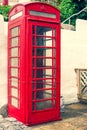 LLandudno, Wales, UK - MAY 27, 2018 An old classic British red phone booth. Traditional red phone box on street. Not working vinta Royalty Free Stock Photo