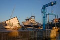 Crane and boat on repair in Llanes harbour at sunset