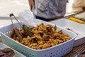 Llardons, Chicharrones is made by compacting and then scrubbing the pork pieces that remain after the grease has been removed, so