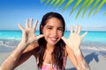 Llatin teen girl playing beach smiling sandy hands Royalty Free Stock Photo