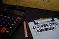 LLC Operating Agreement write on a paperwork isolated on wooden background Royalty Free Stock Photo