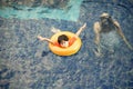 Llittle boy in life ring having fun on swimming pool Royalty Free Stock Photo