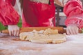 Llittle cute child girl chef preparing the dough on rustic wooden table. Homemade pastry for cookie, bread or pizza. Food and ÃÂ