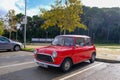 Lloret de Mar, Catalonia, Spain - 11.11.2021: bright red Mini 850 model old retro car in perfect condition parked on the city