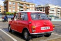 Lloret de Mar, Catalonia, Spain - 11.11.2021: bright red Mini 850 model old retro car in perfect condition parked on the city