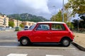 Lloret de Mar, Catalonia, Spain - 11.11.2021: bright red Mini 850 model old retro car in perfect condition parked on the city