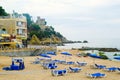 LLORET DE MAR, SPAIN - JULY 28, 2019: Empty beach on early cloudy morning in Costa Brava. Concept of rest. Summer travel