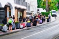 LLORET DE MAR, SPAIN - JULY 27, 2019: Group of tired tourists walks along the street with luggage to the hotel on the Costa Brava