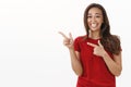 Lmao very funny. Amused and carefree cute carefree brunette woman in red t-shirt having fun, smiling joyfully pointing