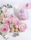 Delicate pink roses, heart and wedding rings