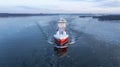 LNG powered oil and chemical tanker making way ahead in Finnish archipelago during winter morning sunrise. Haze in the air and sea Royalty Free Stock Photo