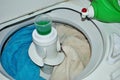 Load of dirty towels in a washing machine with laundry detergent Royalty Free Stock Photo