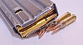 A loaded AR-15 rifle magazine on top of four .223 caliber bullets Royalty Free Stock Photo