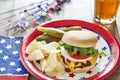 Loaded cheeseburger at a patriotic themed cookout