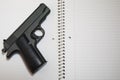 Loaded Handgun on School Notebook