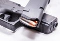 A loaded 9mm pistol magazine on top of a black 9mm pistol Royalty Free Stock Photo