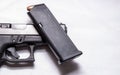 A loaded 9mm pistol magazine on top of a black 9mm pistol Royalty Free Stock Photo