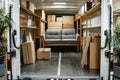 Loaded moving truck interior with a couch and boxes stacked for a residential relocation service. Royalty Free Stock Photo