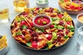 Loaded nachos. Mexican nacho chips with beef, with guacamole sauce Royalty Free Stock Photo