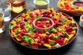 Loaded nachos. Mexican nacho chips with beef, with guacamole sauce Royalty Free Stock Photo