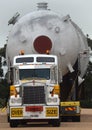 Loaded onto huge multi wheeled heavy haulage trucks are these huge refinery storage vessels. Royalty Free Stock Photo