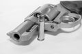 A loaded 357 stainless steel revolver with a hollow point bullet next to it Royalty Free Stock Photo