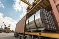 Loaded Steel Coils Secured on a Cargo Trailer Ready for Transport in Industrial Port Area