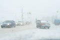 a loaded with traffic highway during massive snowfall, cars, pedestrian, road