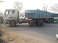 A loaded truck container is making a U-turn on the road causing it to jam.