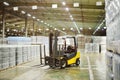 loader on the background of a huge industrial food warehouse with plastic PET bottles with beer, water, drinks.