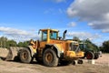 Loader and grapple tractor at construction site