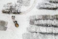 Loader loads logs into the truck stacked in piles covered with snow top view Royalty Free Stock Photo