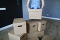 Loader stacks cardboard boxes in an empty room