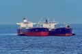 Loading anchored oil supertanker via a ship-to-ship oil transfer