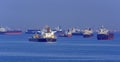 Loading anchored oil supertanker via a ship-to-ship oil transfer