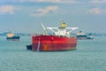 Loading anchored oil supertanker via a ship-to-ship oil transfer