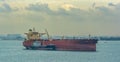 Loading anchored oil supertanker via a ship-to-ship oil transfer STS from raid tanker