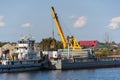 Loading barge with sand and rubble on a small berth. Freight transport logistics.