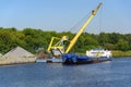 Loading barge with sand and rubble on a small berth. Freight transport logistics. Russia, Moscow region, August 2108