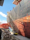 Loading cargo of cement clinker in bulk carrier by ships cranes in the port of Izmir, Turkey.