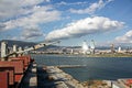 Loading cargo of cement clinker in bulk carrier by ships cranes in the port of Izmir, Turkey. Royalty Free Stock Photo