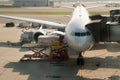 Loading cargo on plane in airport before flight. Royalty Free Stock Photo