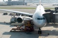 Loading cargo on plane in airport before flight. Foreman control Royalty Free Stock Photo