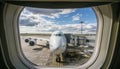 Loading cargo on the plane in airport, view through window Royalty Free Stock Photo