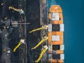 Loading coal anthracite mining in port on cargo tanker ship with crane bucket of train. Aerial top view Royalty Free Stock Photo