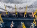 Loading coal mining in port on cargo tanker ship with crane bucket of train. Aerial top view Royalty Free Stock Photo