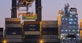 Loading containers on a ship at dawn Royalty Free Stock Photo