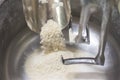 Loading flour into an industrial dough mixer. Close up view.